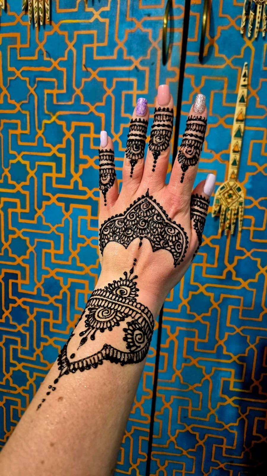 Henna against a blue Moroccan tiled wall